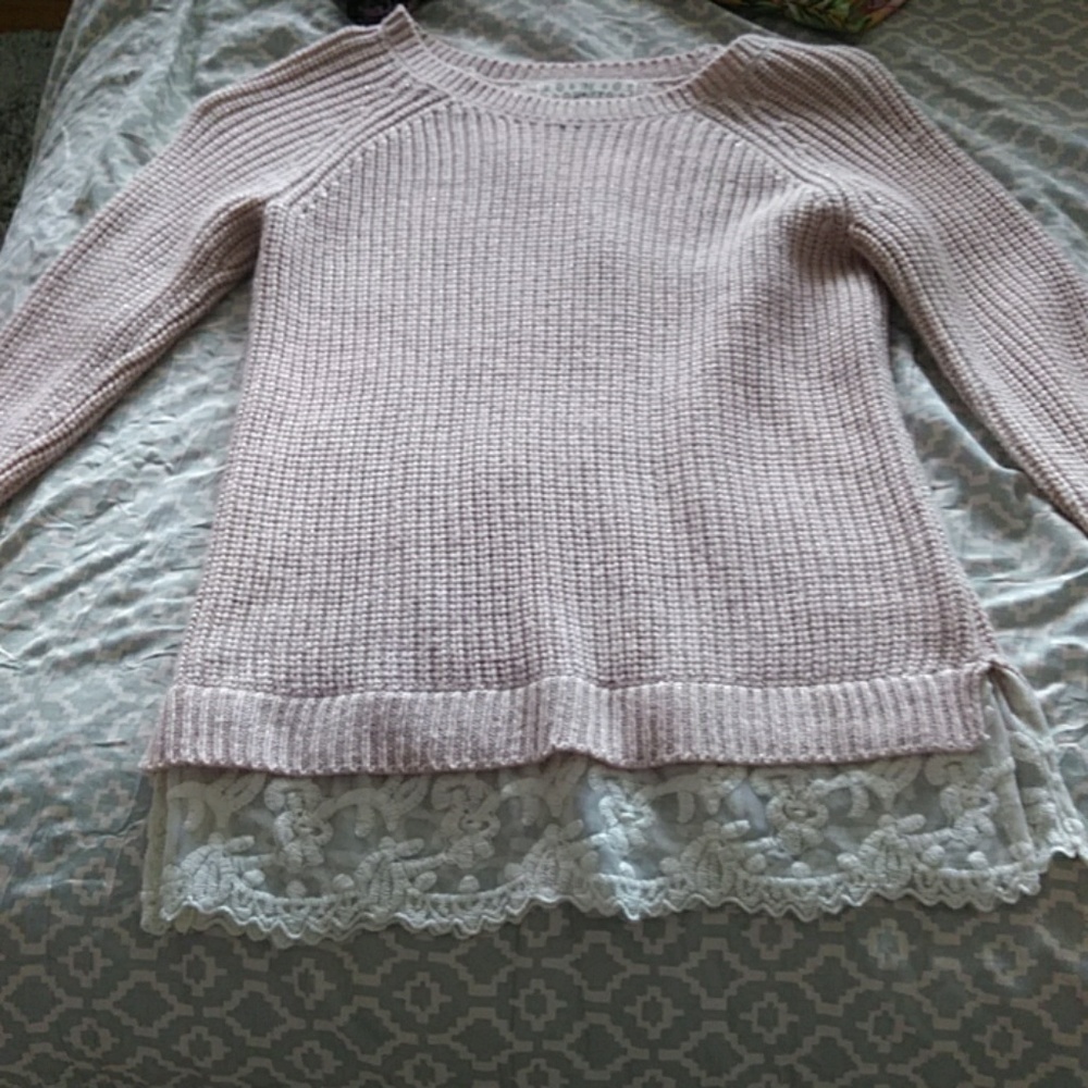 A sweater with lace at the bottom